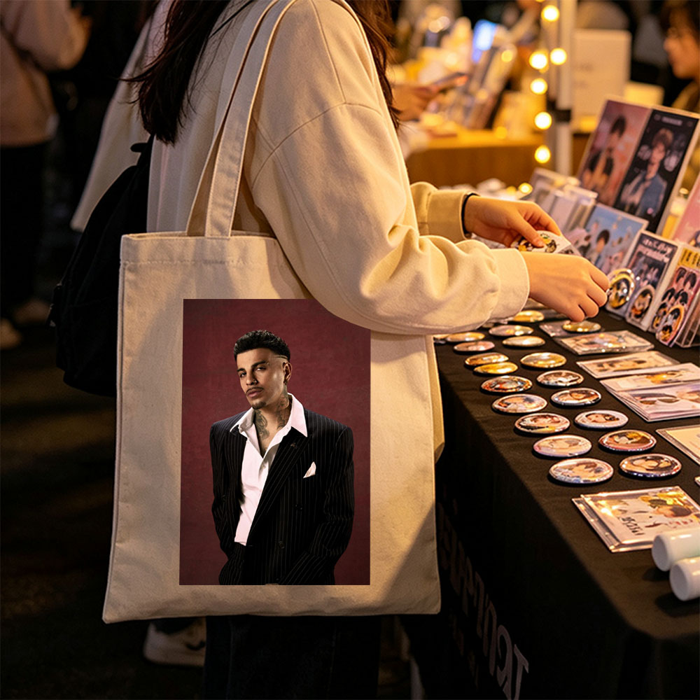 Maluma in a Pinstripe Suit Against a Deep Red Background - Canvas tote bags
