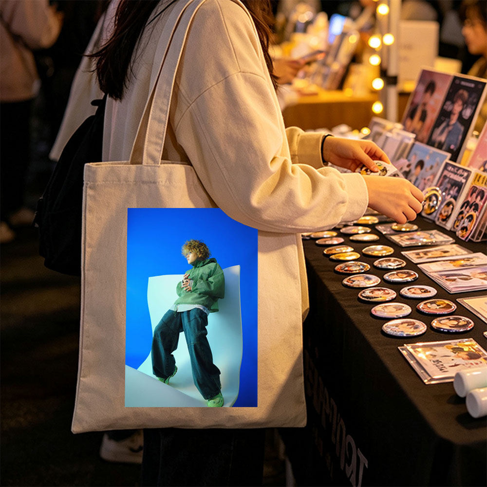 Jaden Smith in a Fashion Shoot Wearing Oversized Green Jacket and Baggy Jeans Against a Blue Background - Canvas tote bags