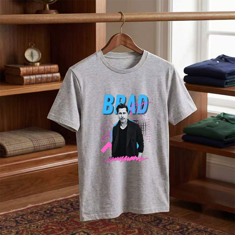 Brad Pitt in a stylish black suit against a vibrant graphic background with bold text and geometric patterns. - Tee