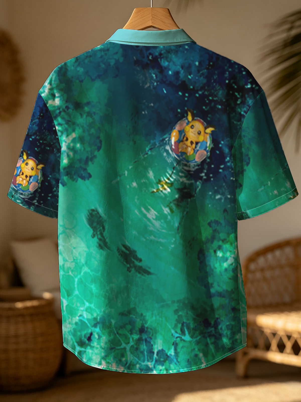 Pikachu floating on a colorful ring in a serene, turquoise pool with fish swimming below. -  Shirt