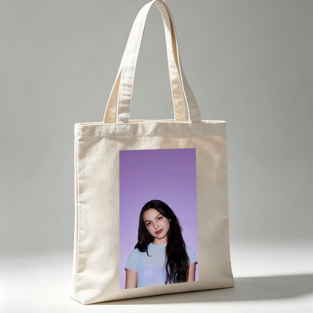 Olivia Rodrigo in a Soft Blue Top Against a Purple Gradient Background - Canvas tote bags