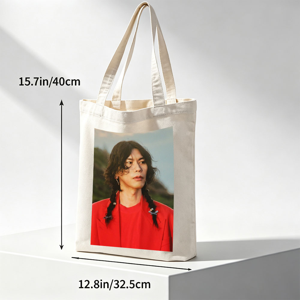 Miyavi in a Bold Red Outfit with Braided Hair and Crossed Pins, Standing Against a Natural Backdrop - Canvas tote bags
