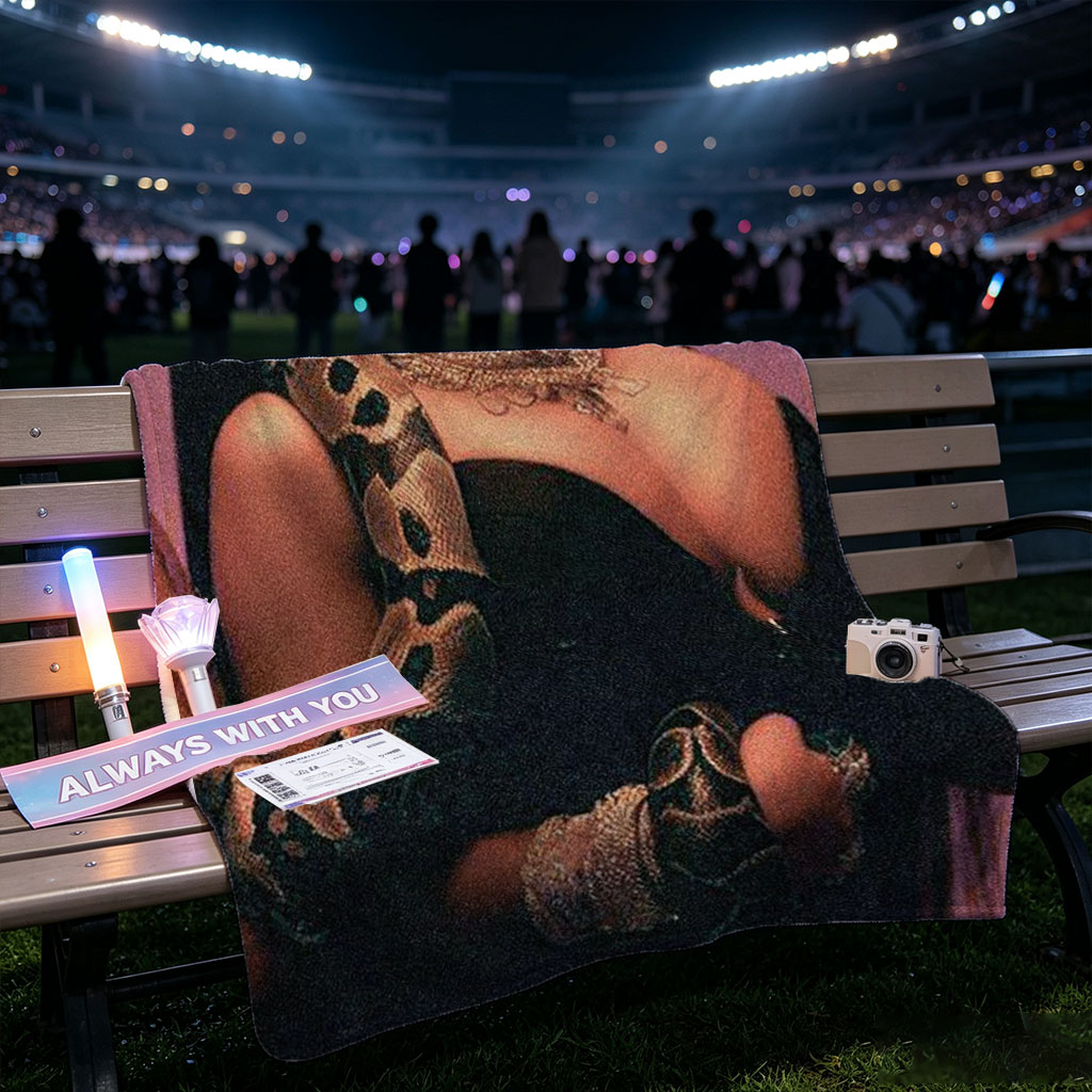 Nicki Minaj in a Dramatic Pose with a Snake Wrapped Around Her Arm and Neck, Wearing a Black Outfit and Heavy Jewelry - Blankets