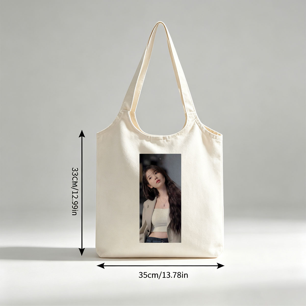 IU in a stylish outfit with a beige blazer and white crop top, showcasing her long wavy hair and elegant necklace. - Canvas shoulder bags/