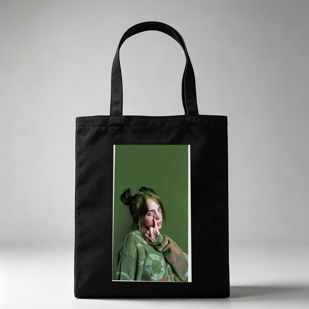 Billie Eilish in Studio Portrait Wearing Green Knit Sweater with Hair in Buns and Fingers on Face - Canvas tote bags