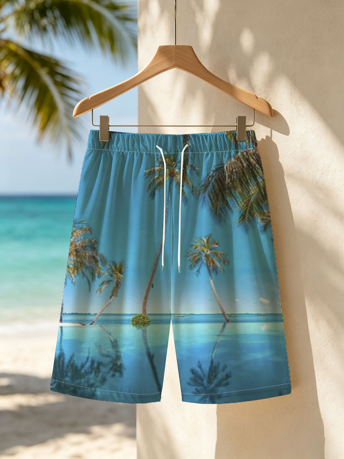 Tropical palm trees reflected in crystal-clear infinity pool under a vibrant blue sky. -  Beach shorts