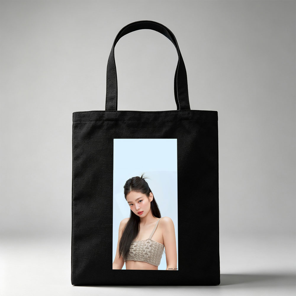 Jennie Kim in a Minimalist Look Wearing a Beige Knit Crop Top Against a Soft Blue Background - Canvas tote bags