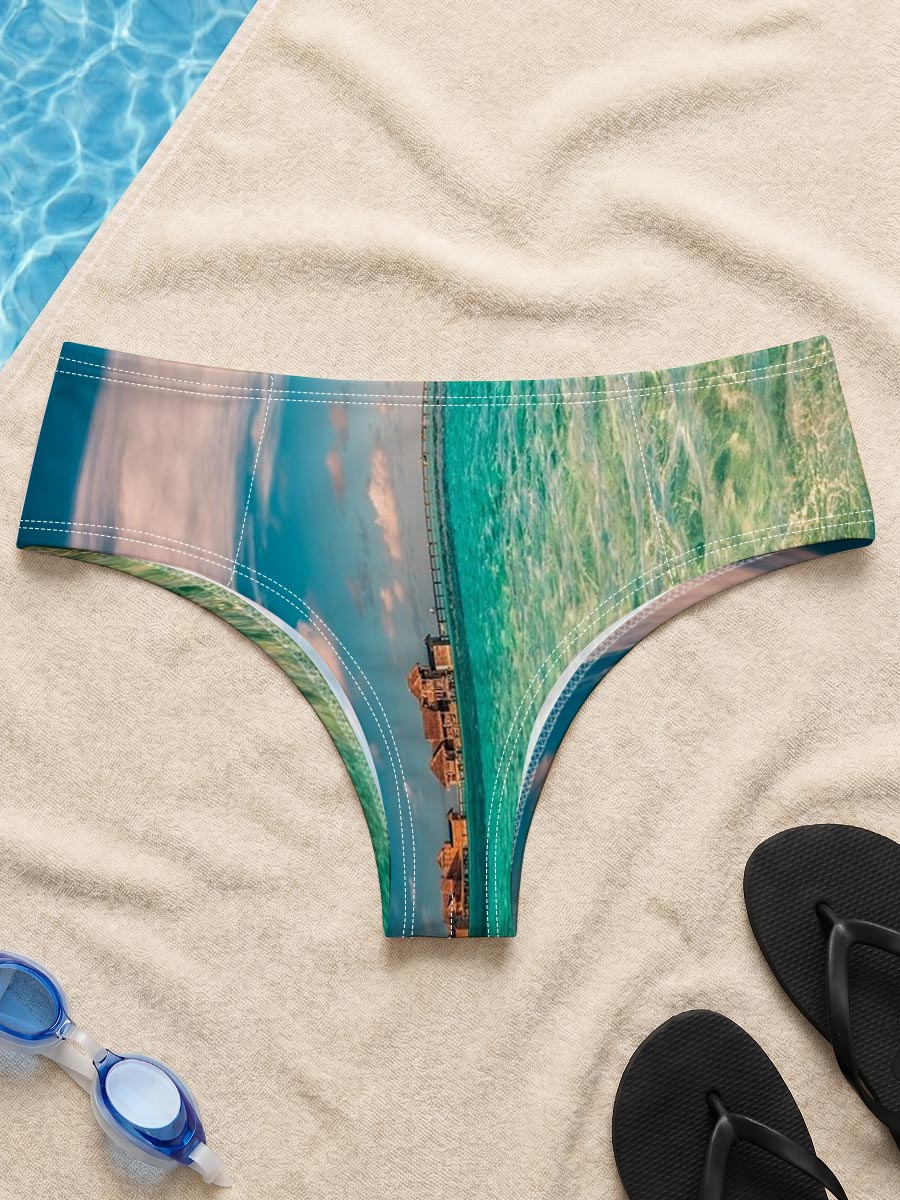 Overwater bungalows stretch into turquoise waters under a vibrant sky. -  Men's swim trunks