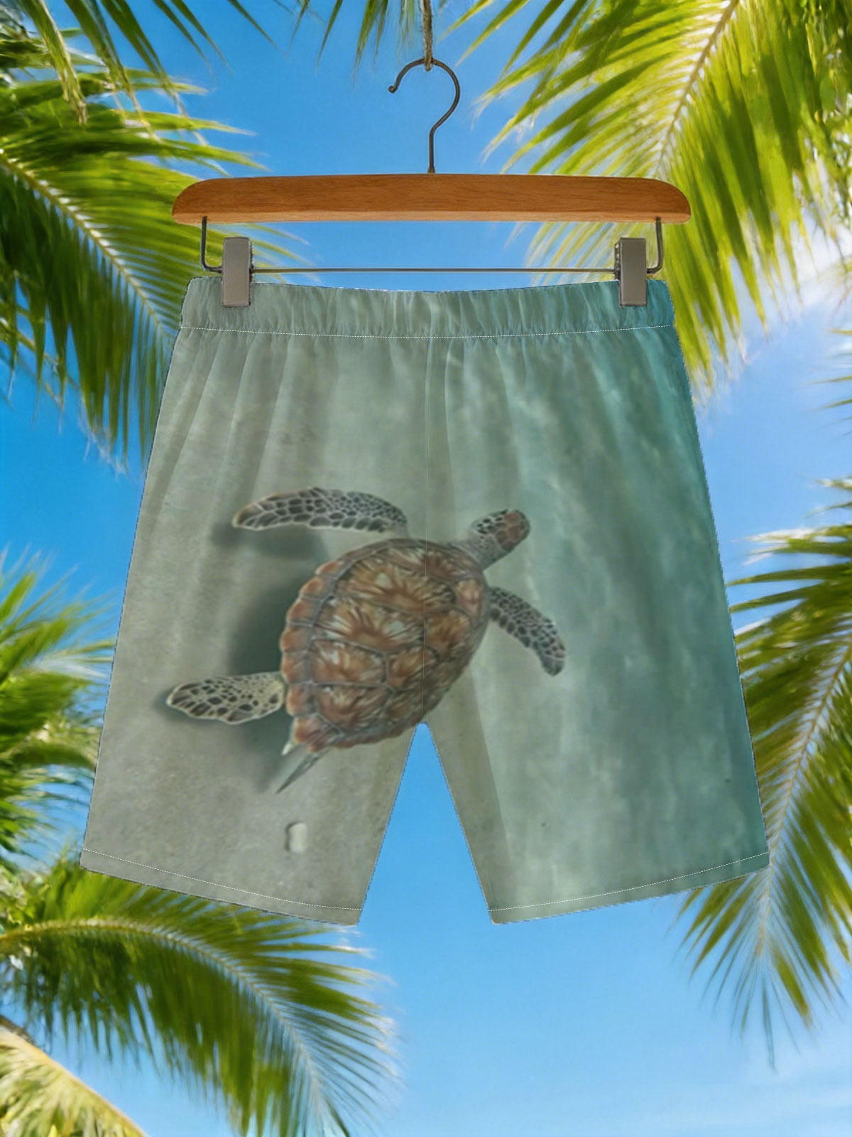 Sea turtle swimming gracefully over sandy ocean floor -  Beach shorts