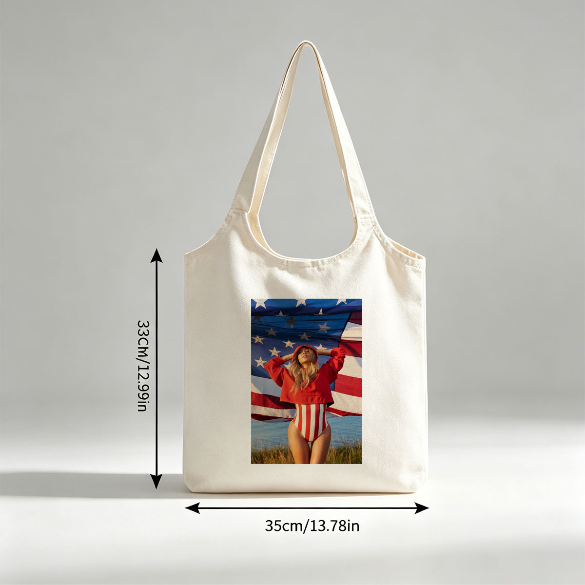 Beyonce in Red Hoodie and Striped Bodysuit Standing Before American Flag by the Beach - Canvas shoulder bags/