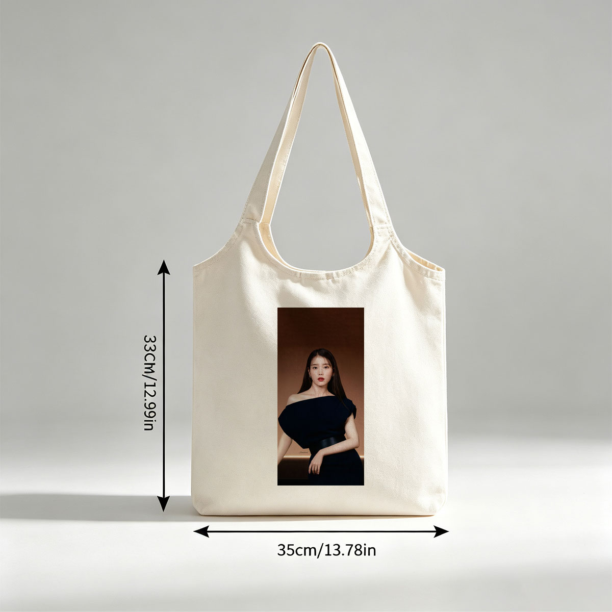IU in Elegant Black Off-Shoulder Dress Against Warm Brown Background - Canvas shoulder bags/