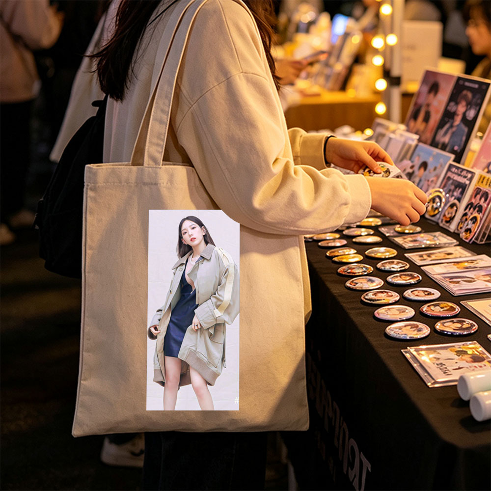 Kim Go Eun in a stylish urban look wearing a beige oversized coat over a navy blue dress, posing confidently against a neutral backdrop. - Canvas tote bags