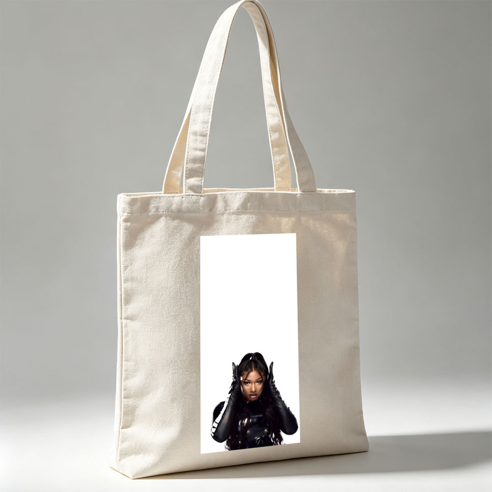 Megan Thee Stallion in a Bold Black Outfit with Hands on Head Against White Background - Canvas tote bags