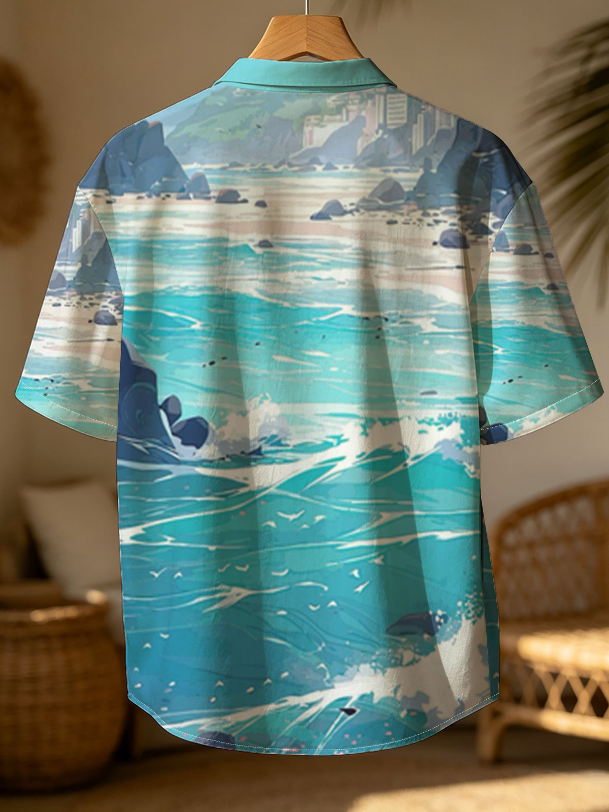 Turquoise waves crash on a rocky beach with distant city skyline and lush green hills under a bright sky. -  Shirt