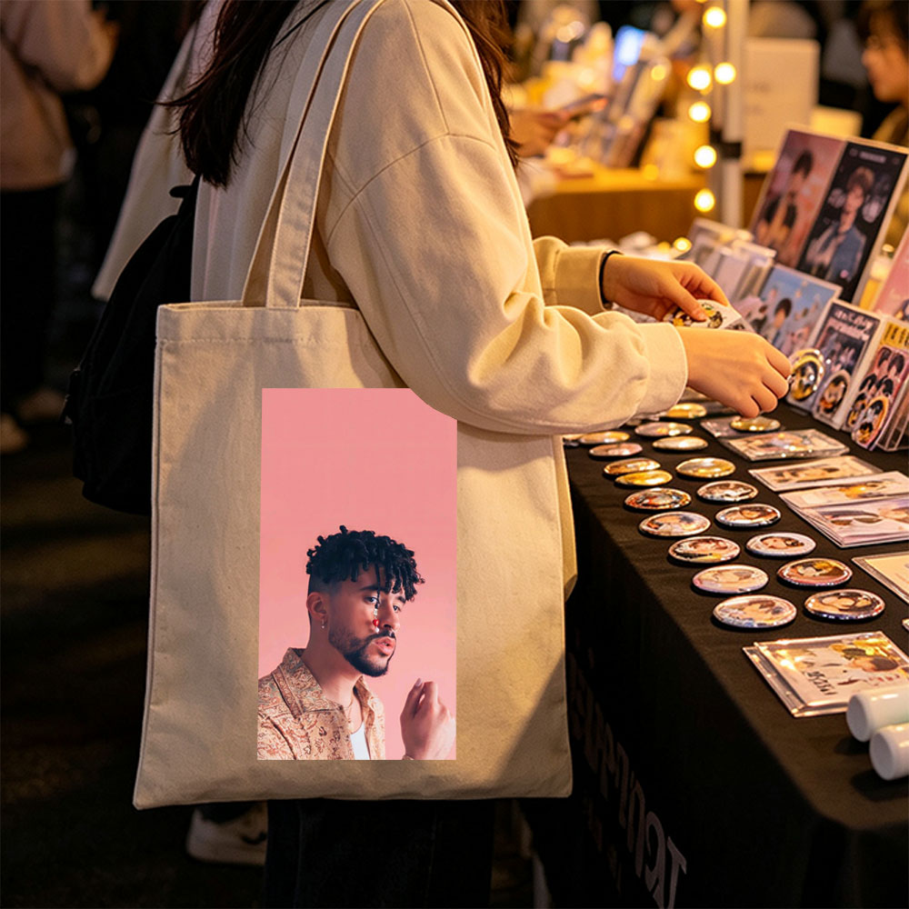 Bad Bunny in a Stylish Pose Against a Pink Background Wearing a Patterned Shirt and Red Nose Jewelry - Canvas tote bags