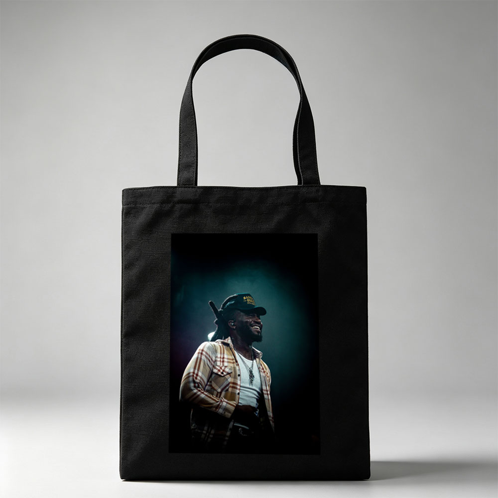 Burna Boy on Stage Performing with a Smile in a Plaid Shirt and Cap - Canvas tote bags