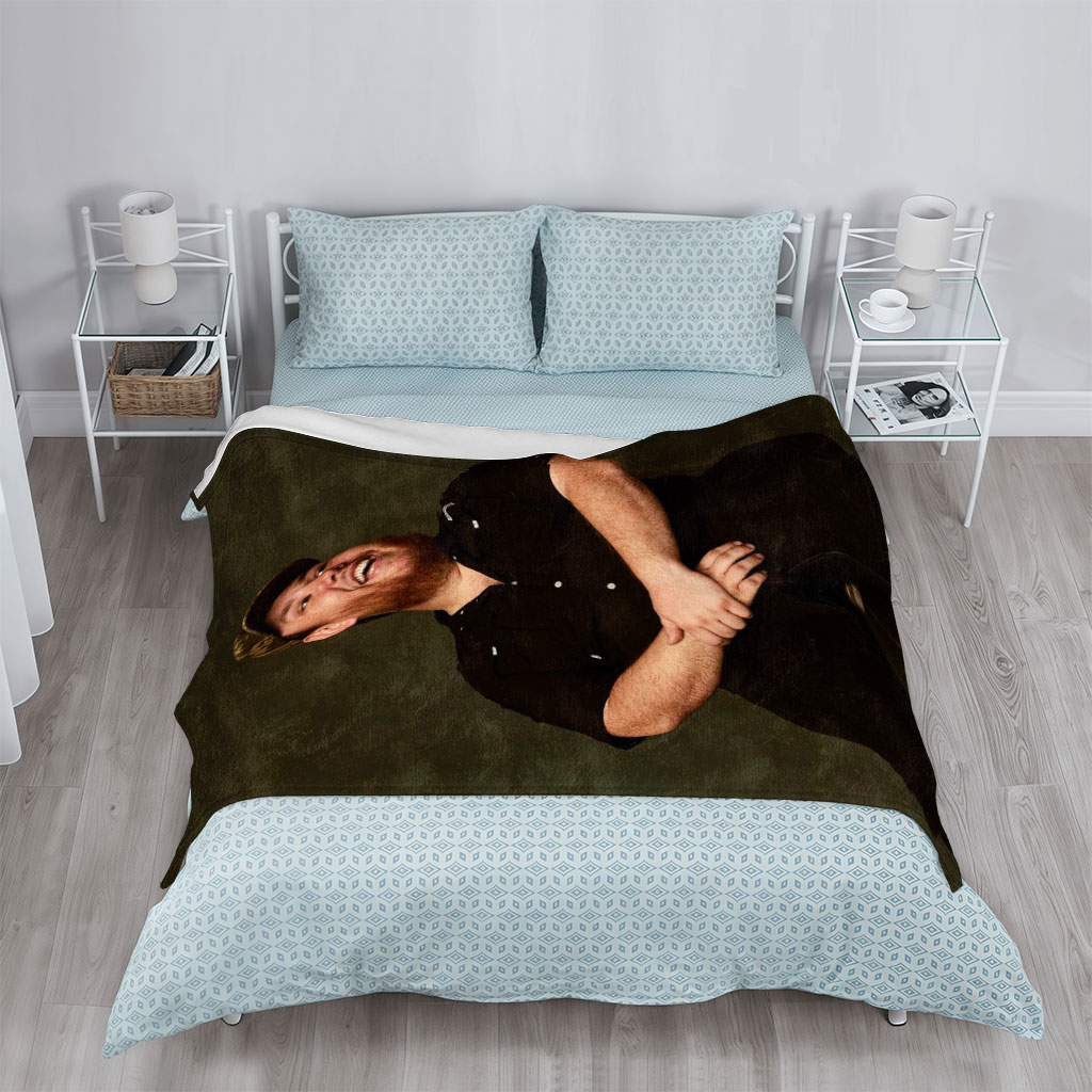 Luke Combs Sitting on a Stool Laughing in a Black Shirt and Cap - Blankets