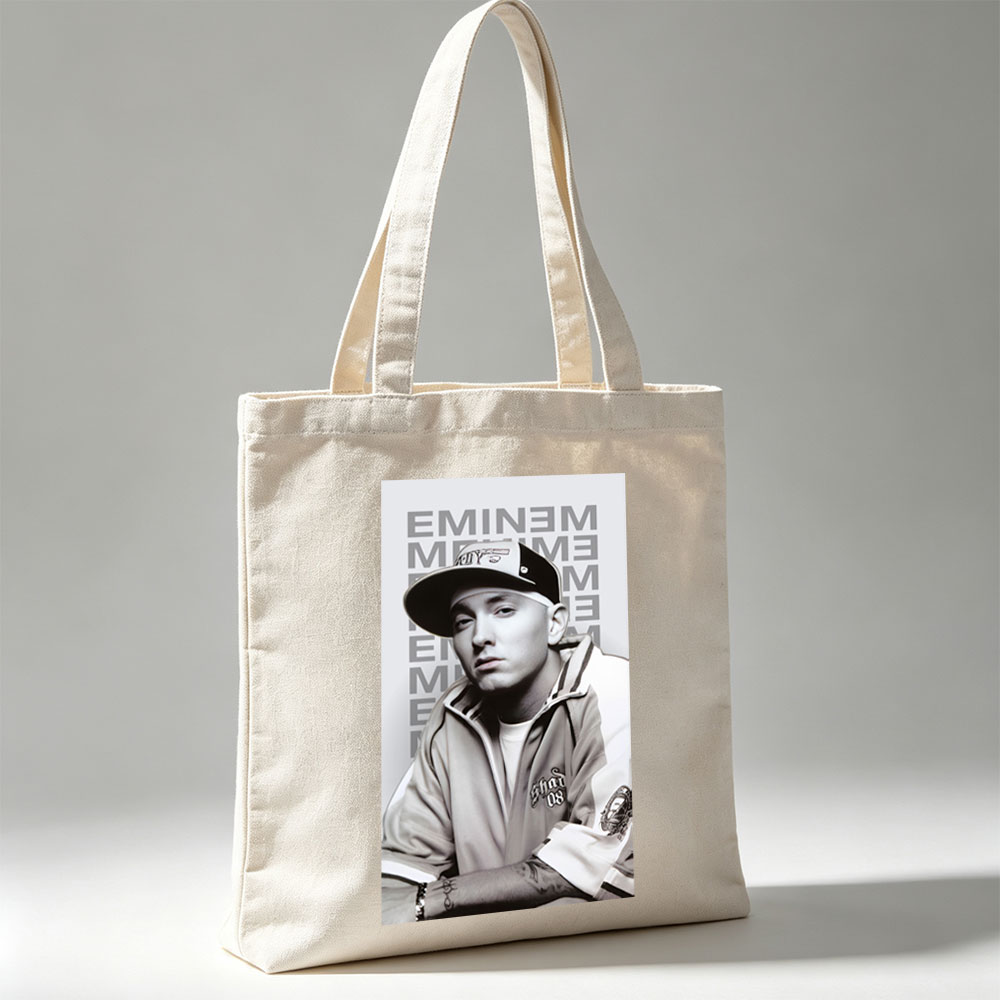 Eminem in a Casual Pose Wearing a Cap and Track Jacket with Tattooed Arms - Canvas tote bags