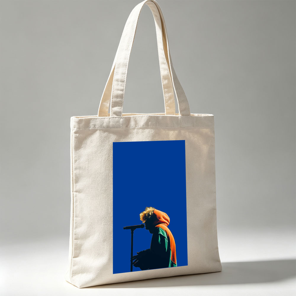 Troye Sivan Performing on Stage with Microphone Against Blue Background - Canvas tote bags