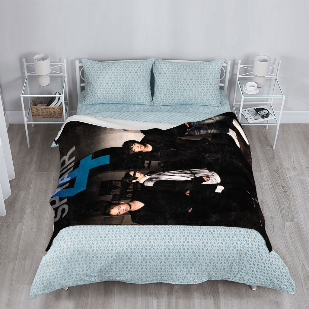 SPYAIR Band Members Standing in a Dimly Lit Room with Bold Number 4 and Band Name Overlay - Blankets