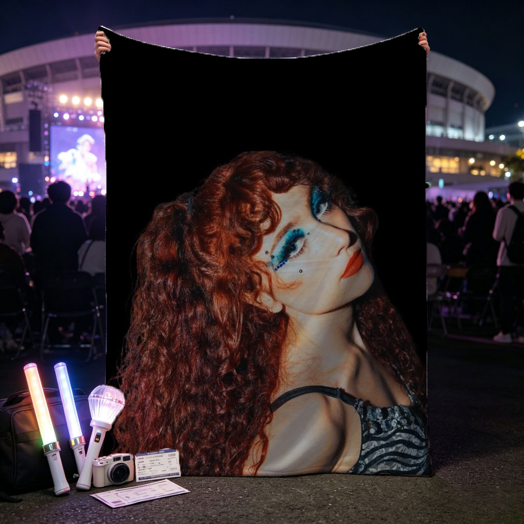 Chappell Roan in a Dramatic Pose with Vibrant Red Hair and Bold Blue Eye Makeup Against a Dark Background - Blankets