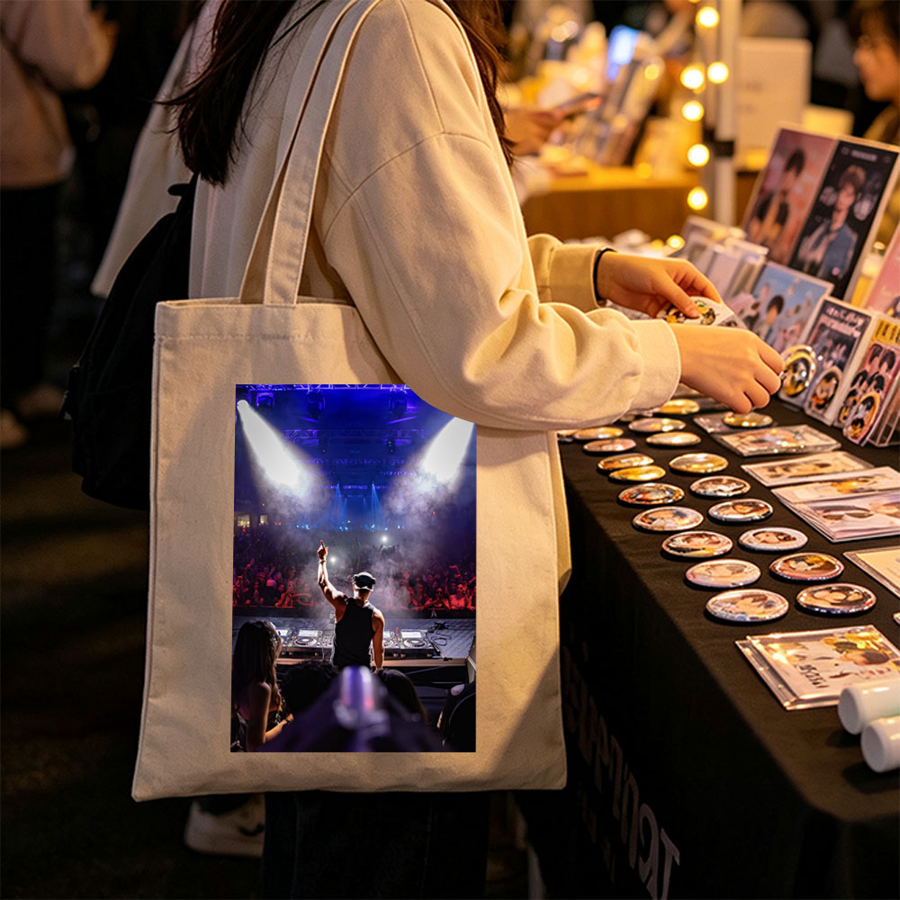 DJ Martin Garrix Performing at a High-Energy Concert with Crowd in the Background - Canvas tote bags