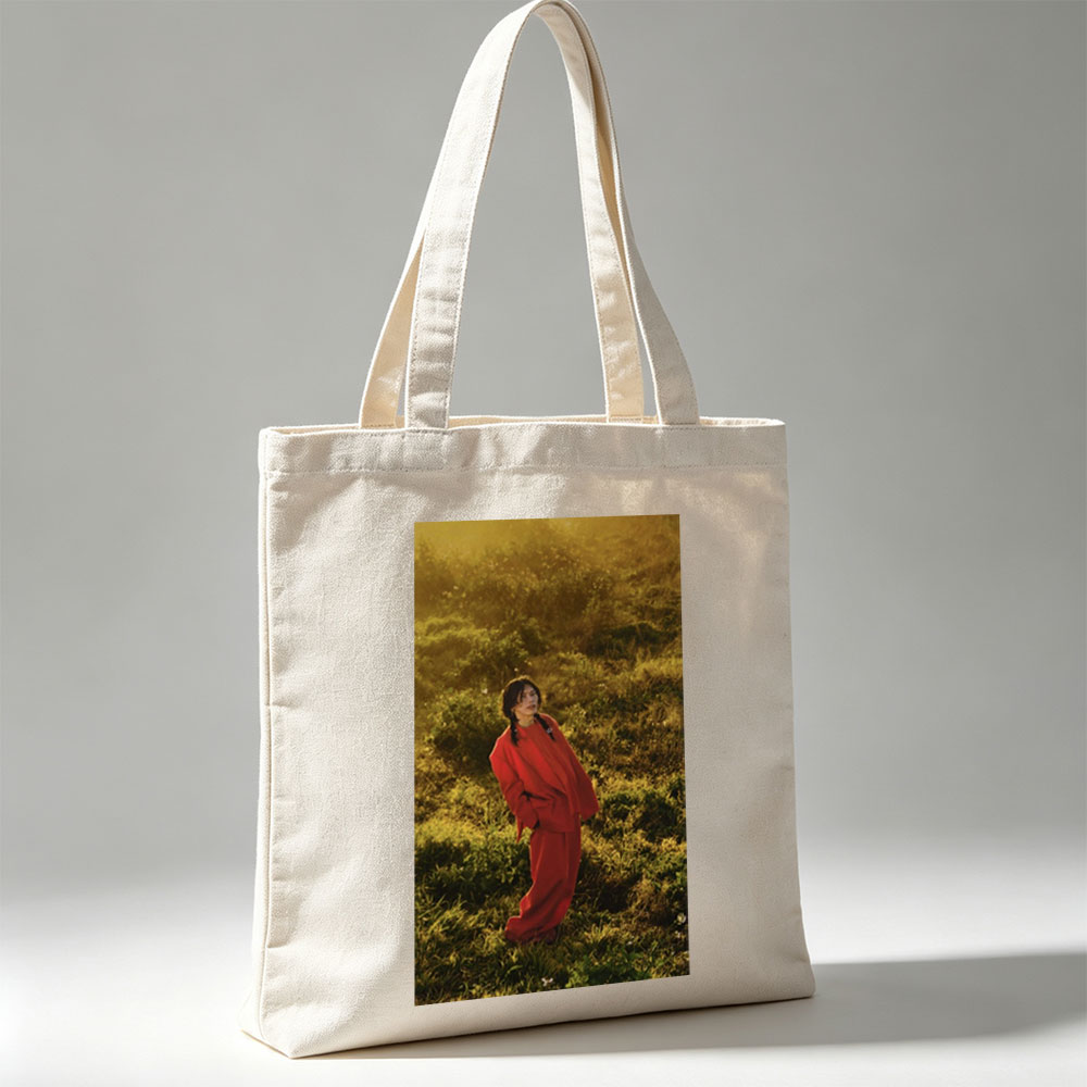 Billie Eilish in a Field Wearing a Red Outfit at Sunset - Canvas tote bags