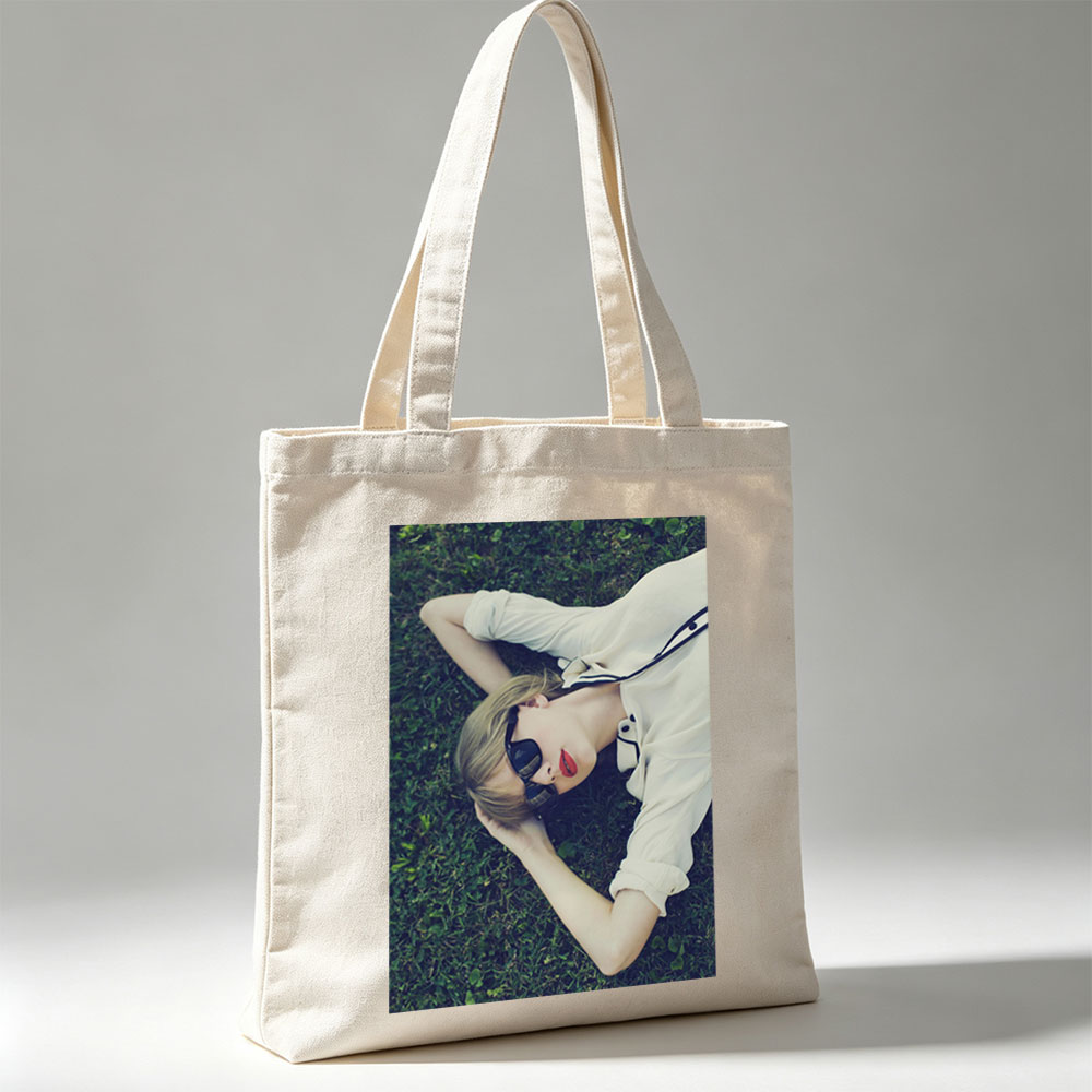 Taylor Swift Lying on Grass Wearing Sunglasses and Red Lipstick - Canvas tote bags