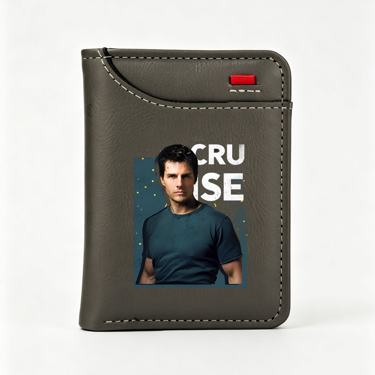 Tom Cruise in a dark blue t-shirt, intense gaze, bold text 