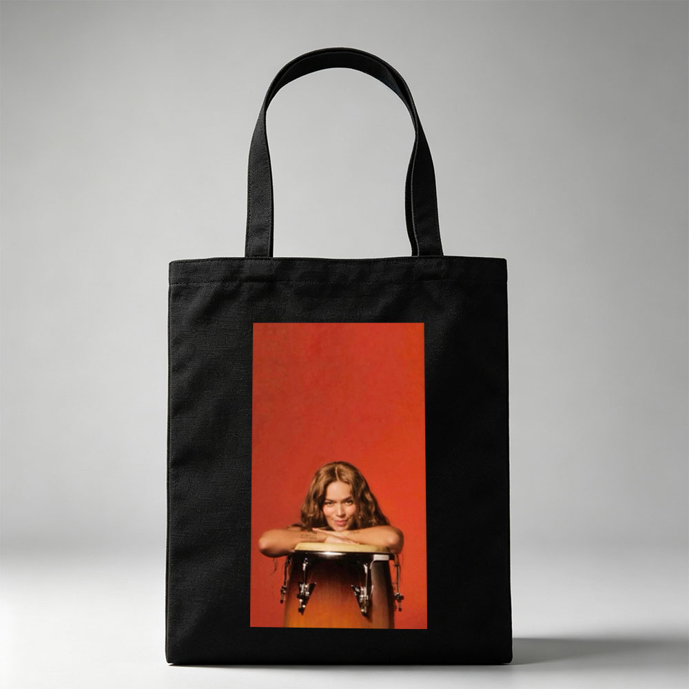Rita Ora Leaning on a Drum Against a Red Background - Canvas tote bags
