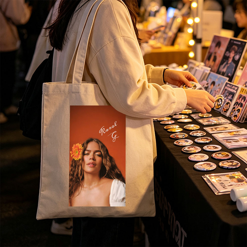 Ranal G with a vibrant orange flower in her hair against a warm terracotta background - Canvas tote bags