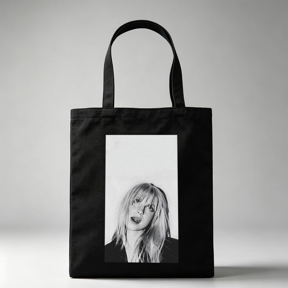 Bebe Rexha in a striking black and white portrait with tousled blonde hair and bold expression - Canvas tote bags