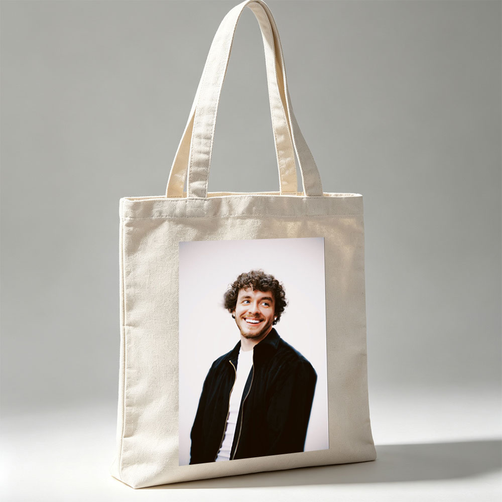 Matt Healy of The 1975 in a Candid Moment Wearing a Black Jacket and White Shirt Against a Plain Background - Canvas tote bags