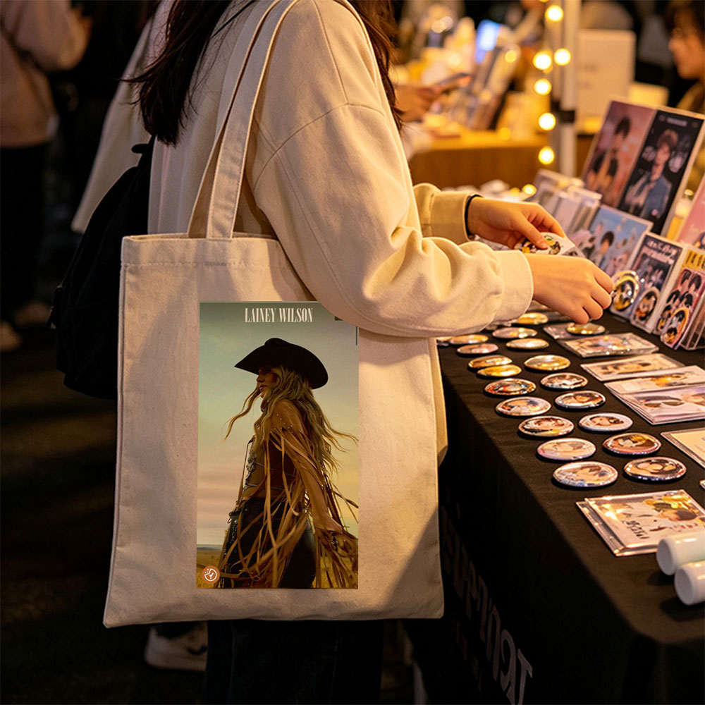 Lainey Wilson in a Cowboy Outfit Standing in a Field at Sunset - Canvas tote bags