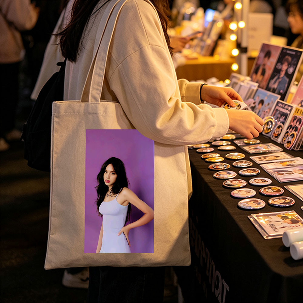 Olivia Rodrigo in a Light Blue Dress Posing Against Purple Background - Canvas tote bags