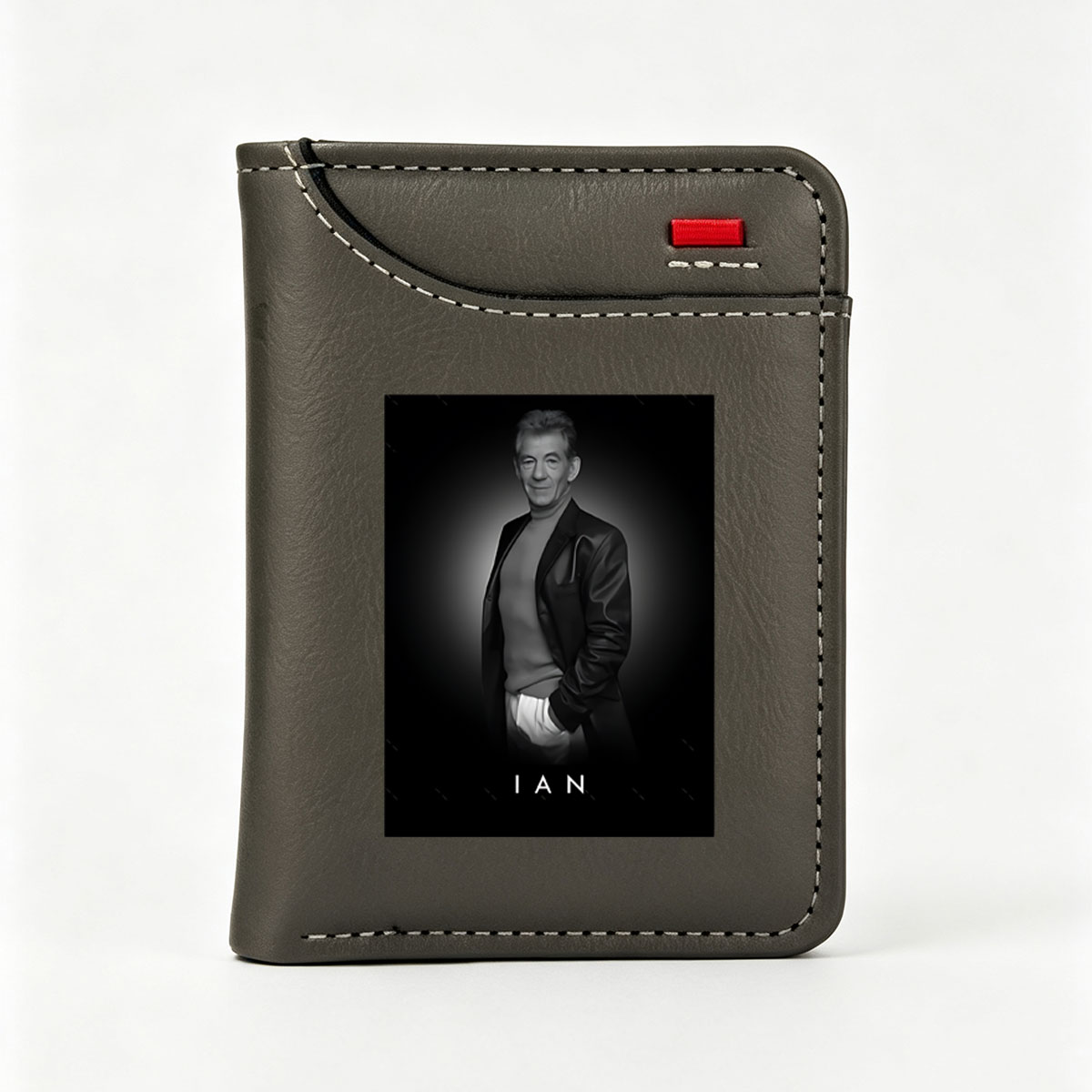 Ian McKellen in a stylish black suit, exuding elegance and confidence against a dark background. - Vertical Style Wallet