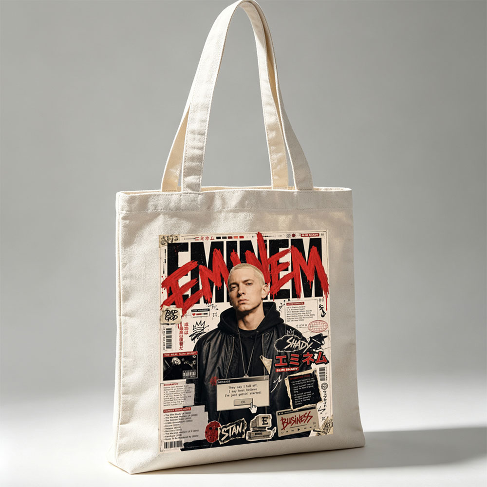 Eminem on a vibrant magazine cover featuring bold red text, career highlights, and iconic album references. - Canvas tote bags