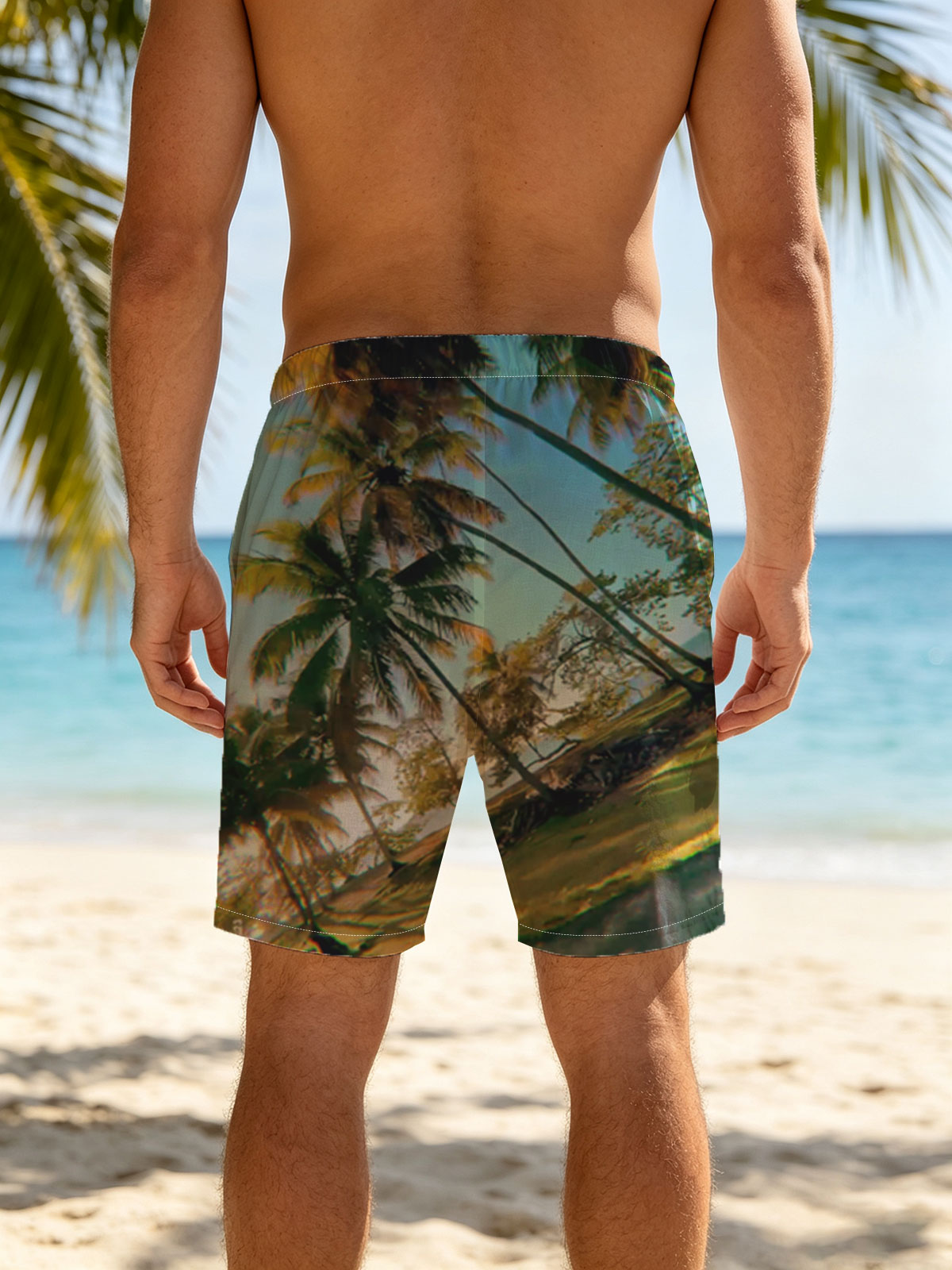 Tropical palm trees sway under a clear blue sky, casting golden shadows on the ground. -  Beach shorts