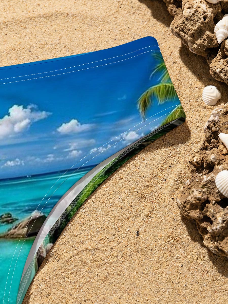 Couple relaxing on a tropical beach with turquoise waters and palm trees -  Men's swim trunks