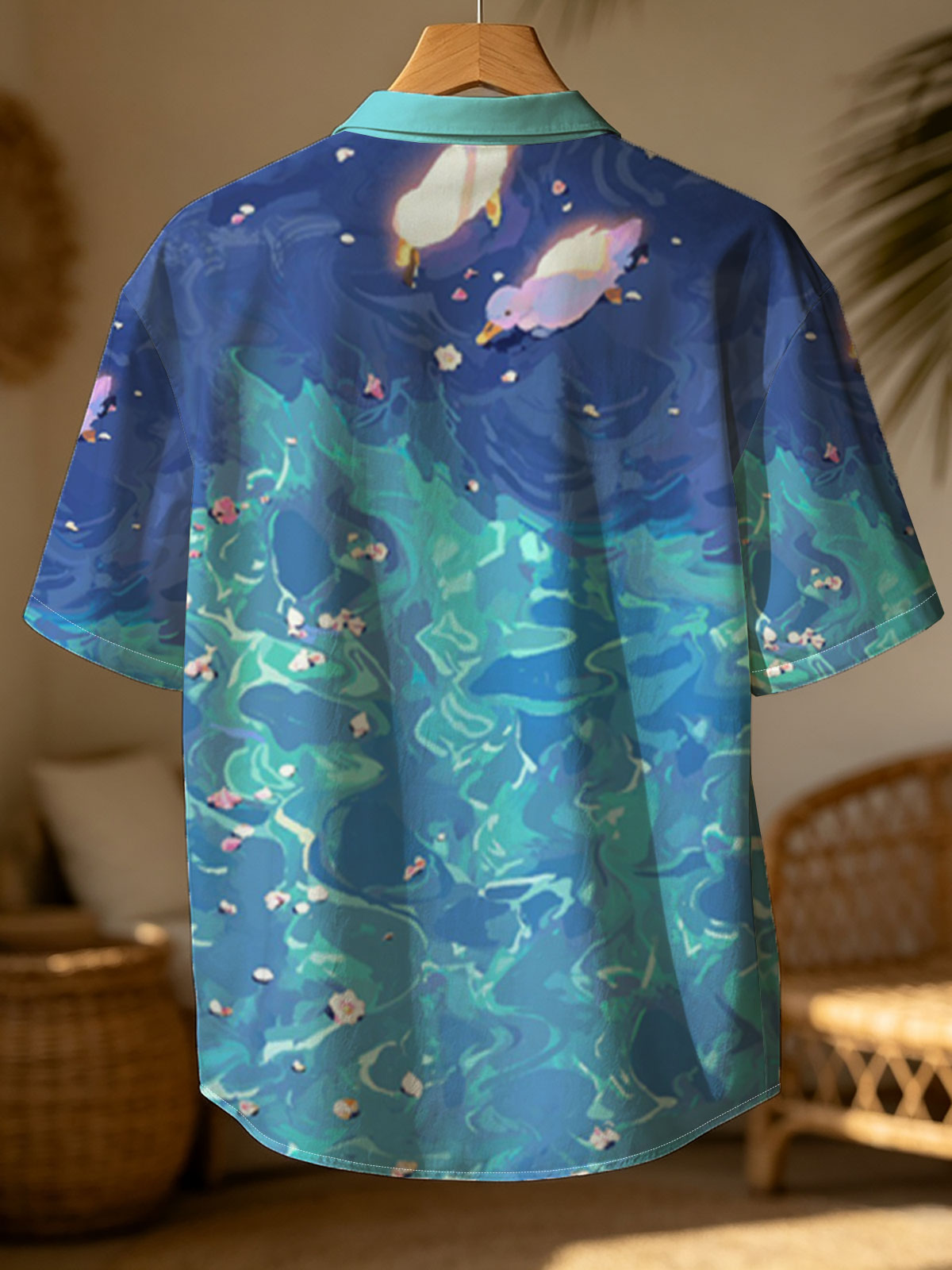 Ducks floating on a vibrant blue pond with scattered petals -  Shirt