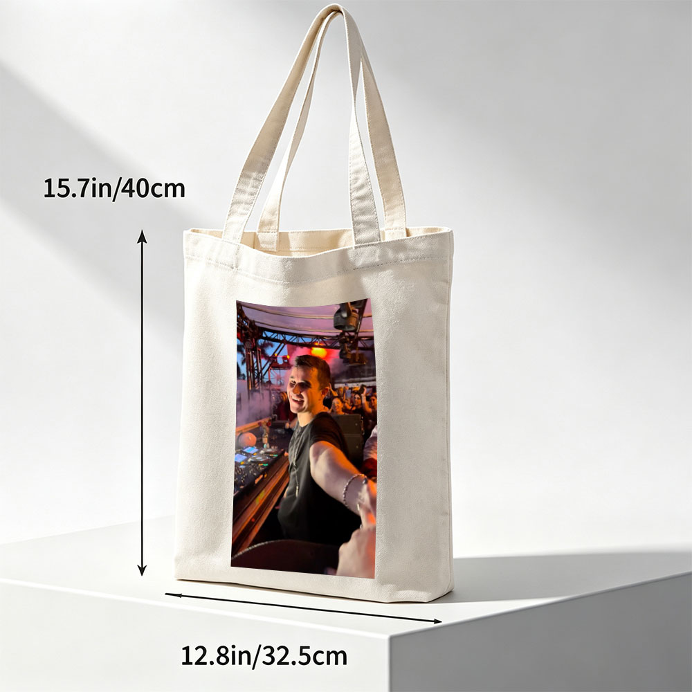 Martin Garrix at a Live DJ Set Performing for an Energetic Crowd Under Colorful Stage Lights - Canvas tote bags