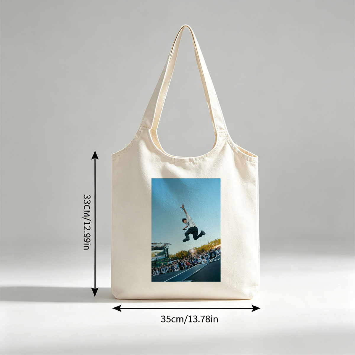 Skateboarder in Mid-Air Trick at Outdoor Festival with Crowd Watching - Canvas shoulder bags/