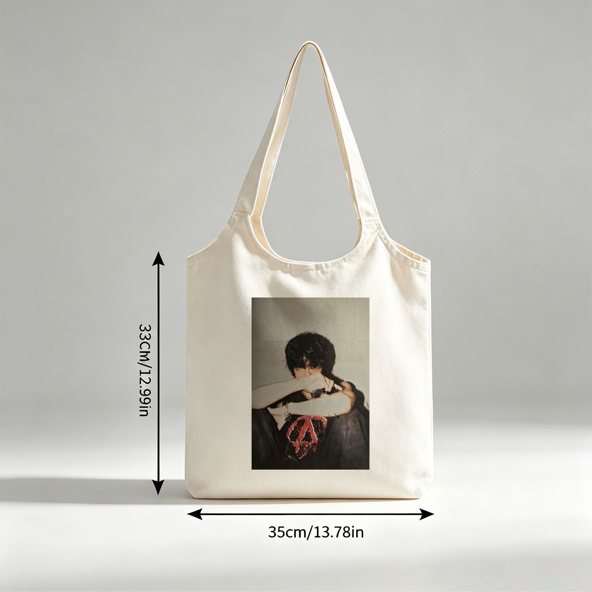 Hyunjin of Stray Kids in a Moody Pose with Sunglasses and Cross Tattoo, Wearing a Black T-Shirt with Red Peace Symbol Design - Canvas shoulder bags/