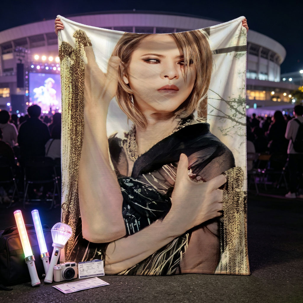 Cher in a Dramatic Pose Wearing a Black and Gold Outfit with Flowing Fabric - Blankets