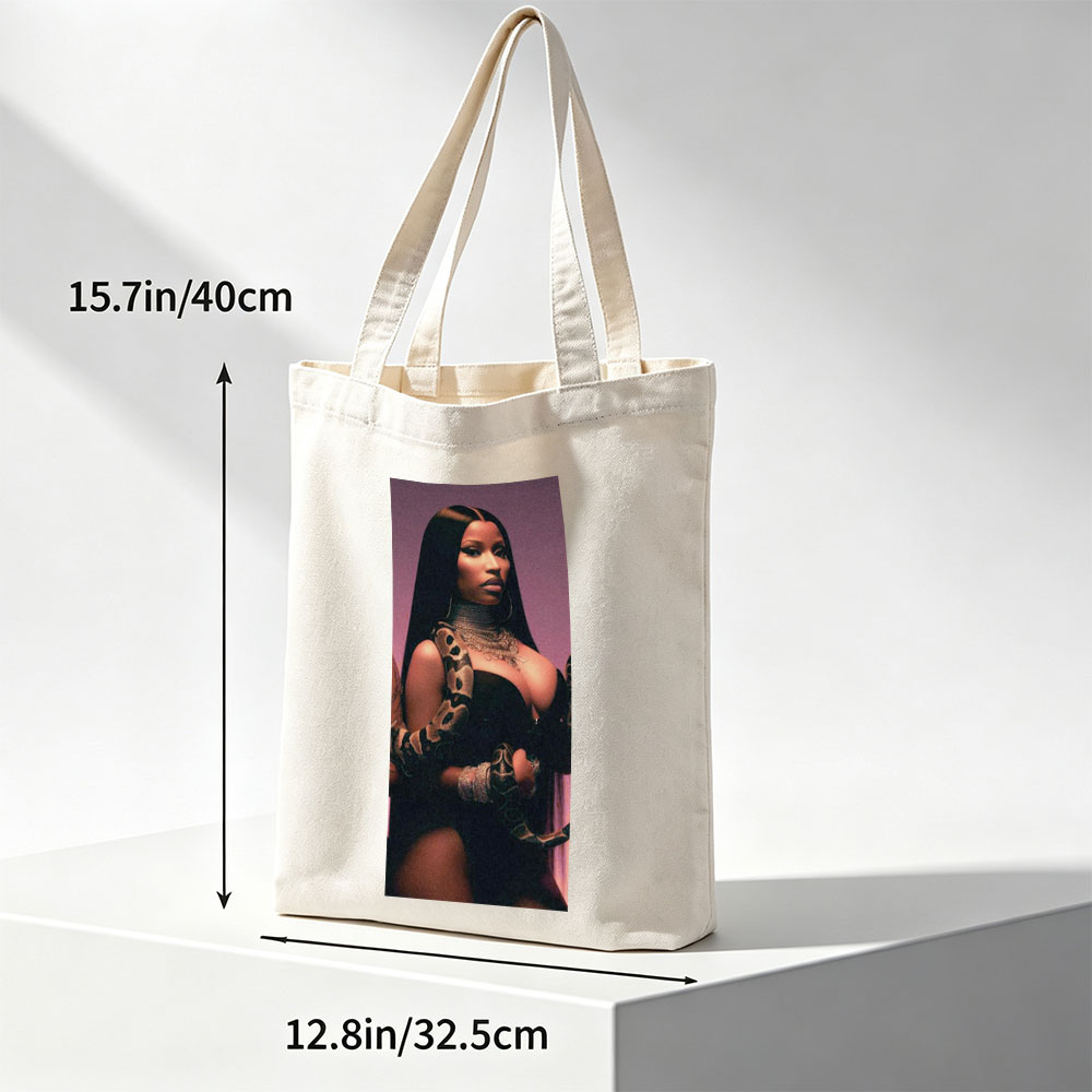 Nicki Minaj in a Dramatic Pose with a Snake Wrapped Around Her Arm and Neck, Wearing a Black Outfit and Heavy Jewelry - Canvas tote bags