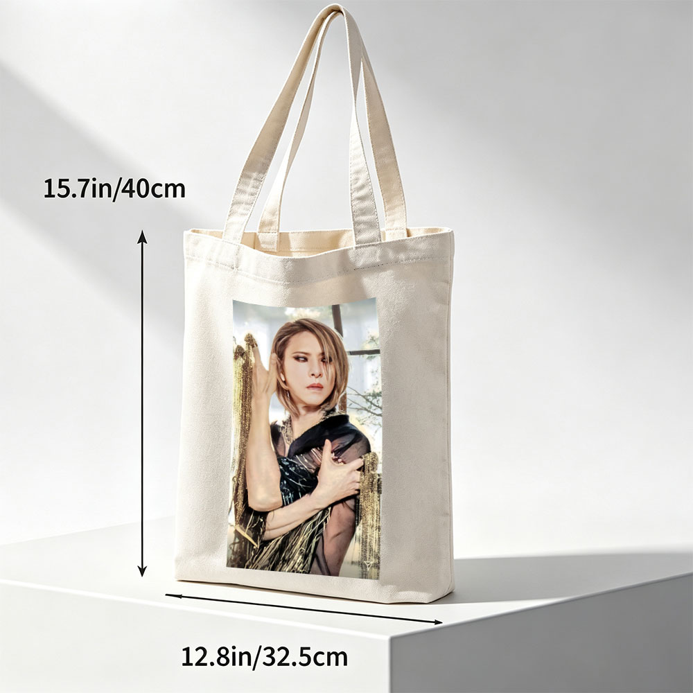 Cher in a Dramatic Pose Wearing a Black and Gold Outfit with Flowing Fabric - Canvas tote bags