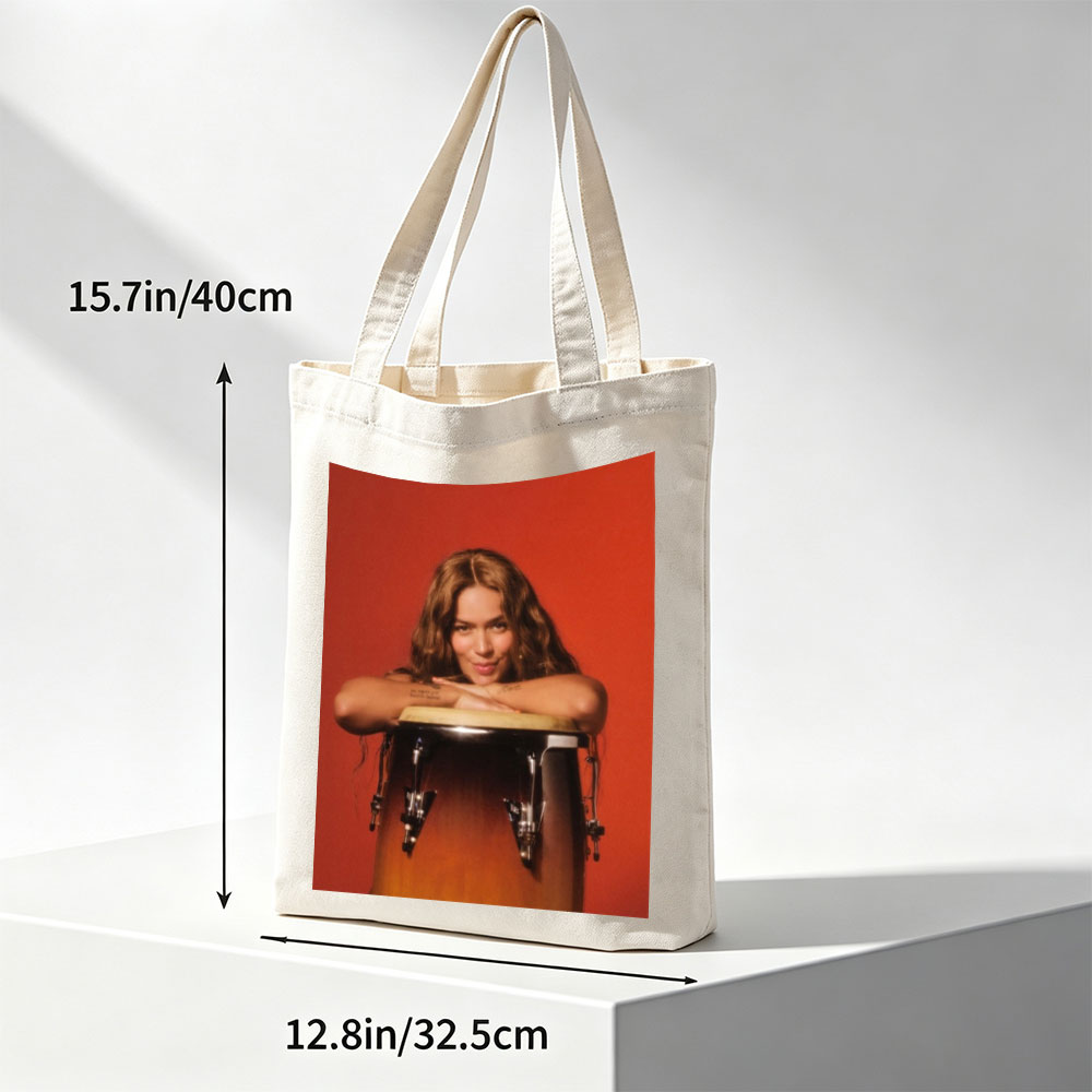 Maren Morris Leaning on a Conga Drum Against a Red Background - Canvas tote bags