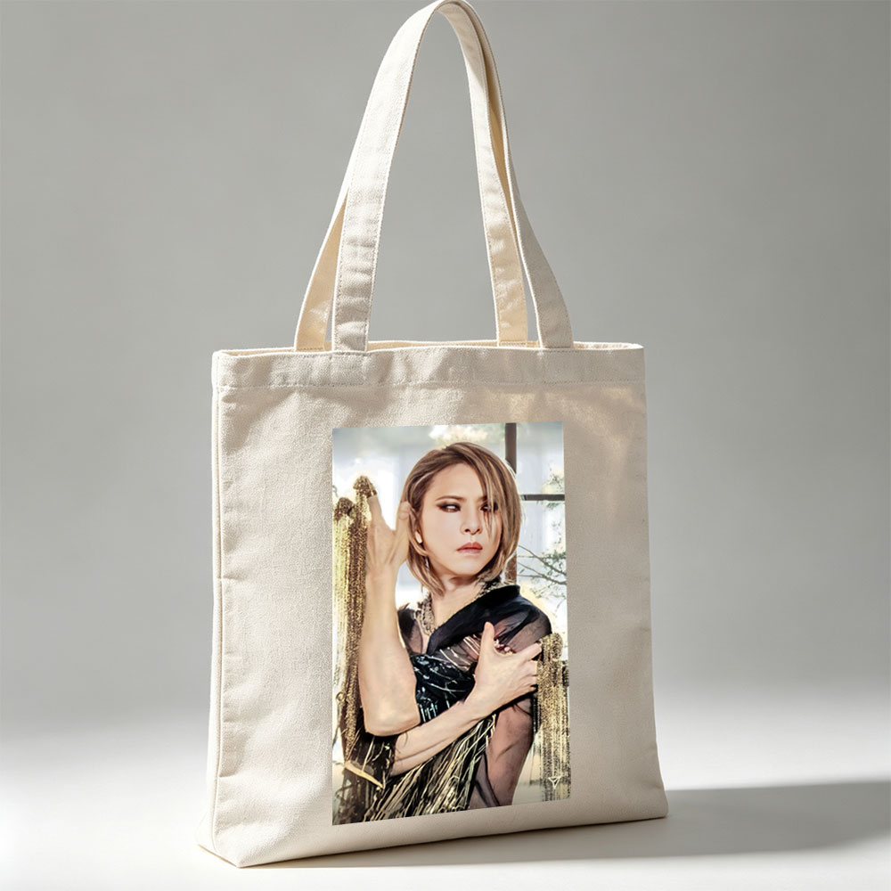 Cher in a Dramatic Pose Wearing a Black and Gold Outfit with Flowing Fabric - Canvas tote bags