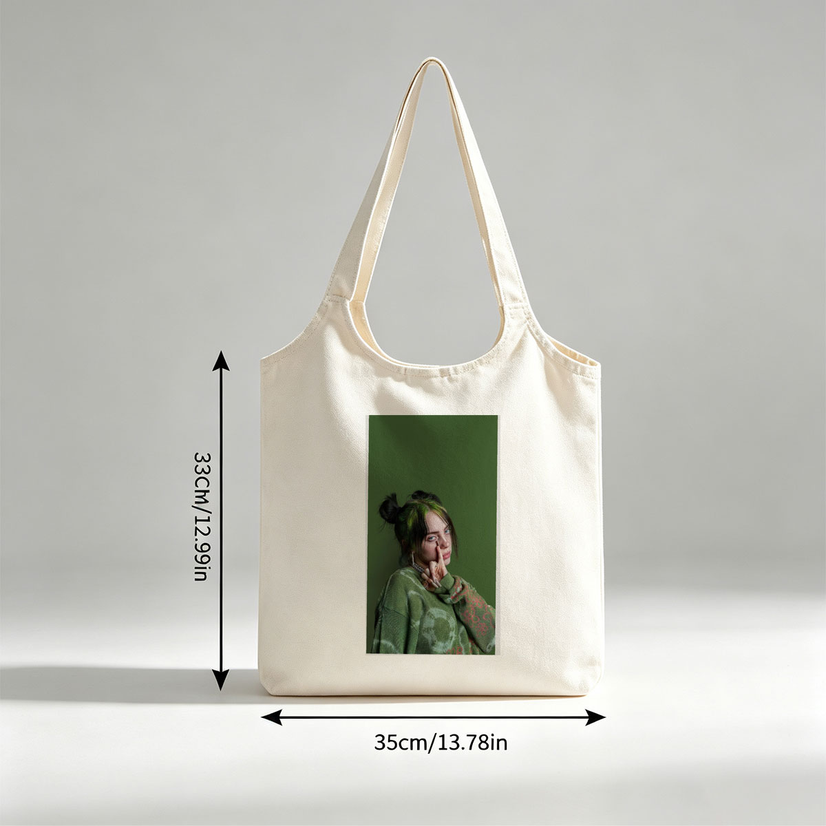 Billie Eilish in Studio Portrait Wearing Green Knit Sweater with Hair in Buns and Fingers on Face - Canvas shoulder bags/