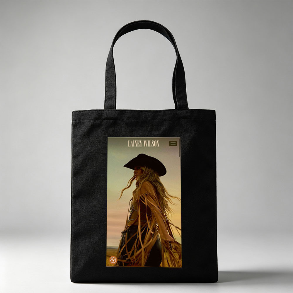 Lainey Wilson in a Cowboy Outfit Standing in a Field at Sunset - Canvas tote bags